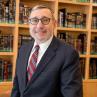 Headshot of Moshe Sokol in library setting.