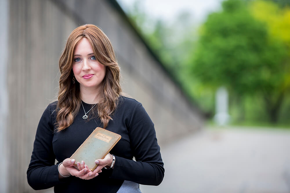 Julie Golding, holding a siddur her grandmother had with her during the Holocaust